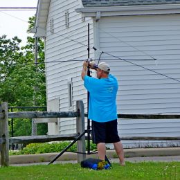 man erecting a portable ham radio antenna