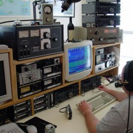 an operator at a large home ham radio station