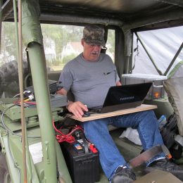 ham radio operator in the back of a military vehicle