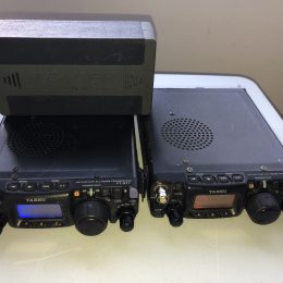 a pair of mobile ham radios set on a desk