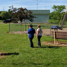 two children using a small ham radio antenna