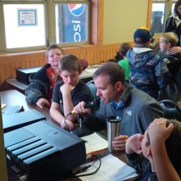 group of ham radio operators working inside