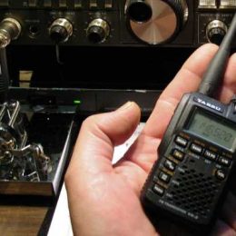 person holding a small handheld ham radio