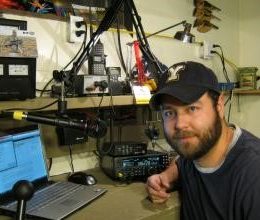 man in a home ham radio station
