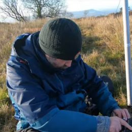 man setting up a temporary ham radio station outside