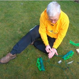 man assembling a wire antenna outside