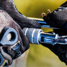 close up of a climber hooking on a carabiner