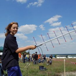 young woman holding a ham radio antenna