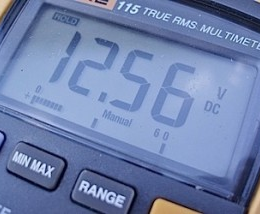 Multimeter screen displaying 12.56 volts