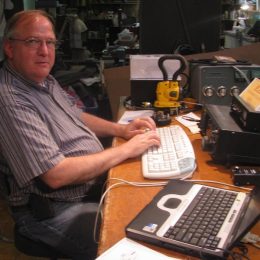 man working keyboard at ham radio station