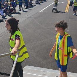 kids in vests near a parade event