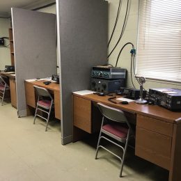 a row of ham radio stations in an office