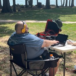 man operating a field day ham radio station at a lighthouse