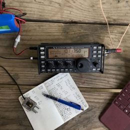 Elecraft KX2 Transceiver on table with logbook