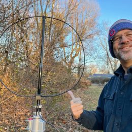 man next to ham radio magnetic loop antenna