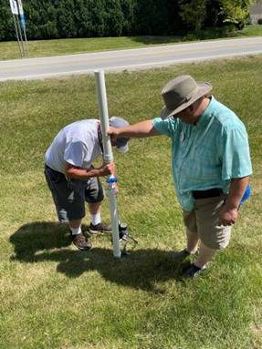 Two men setting up an antenna at Field Day