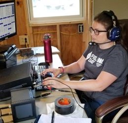 woman at desk of a ham radio station