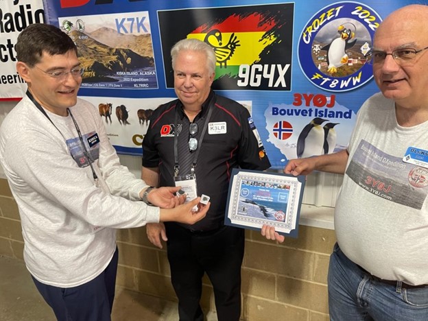 Tim Duffy, K3LR, of DX Engineering is presented a rock and some sand from Bouvet Island