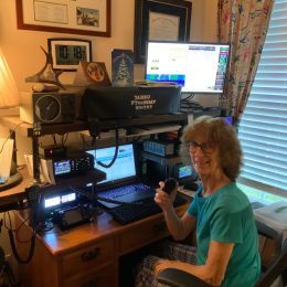 Woman sitting at a ham radio station