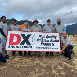 Juan Fernandez DXpedition team holding DX Engineering banner