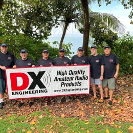 A group of people standing behind a banner