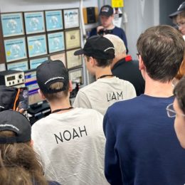 group of teenagers observing a hamr radio in action