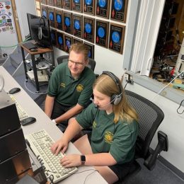 two ham radio operators at a keyboard