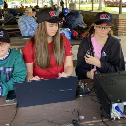 young ham radio operators at a transceiver
