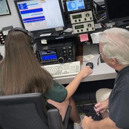 Young woman at controls of a ham radio