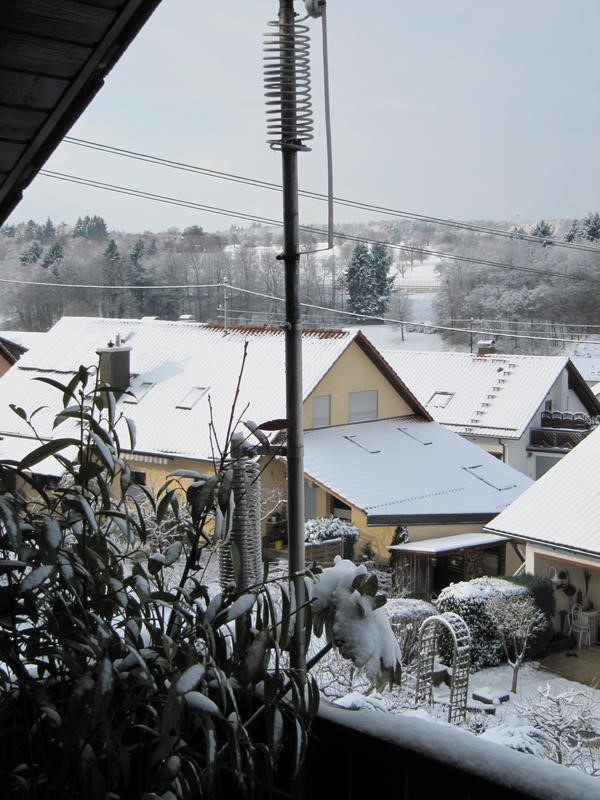 ham radio antenna installed on a snow covered balcony