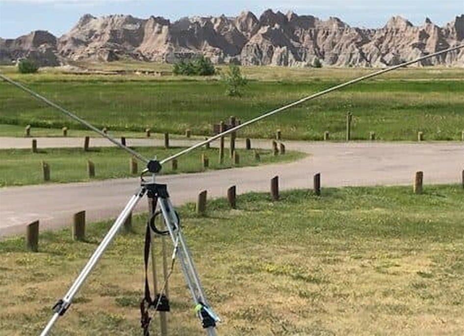 dipole antenna on grassland near mountains