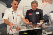 2 men talking near an rf amplifier
