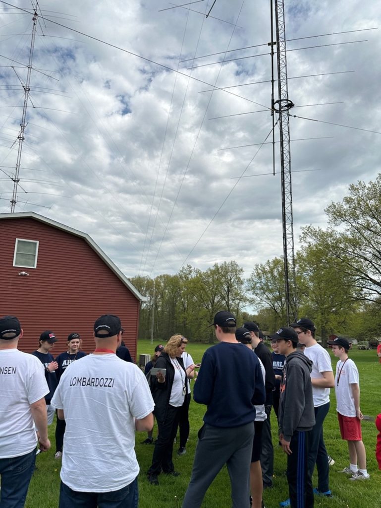 ham radio operators outside near vertical antenna