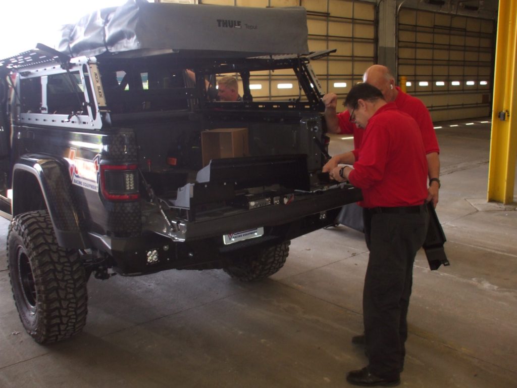 men working o jeep gladiator tailgate