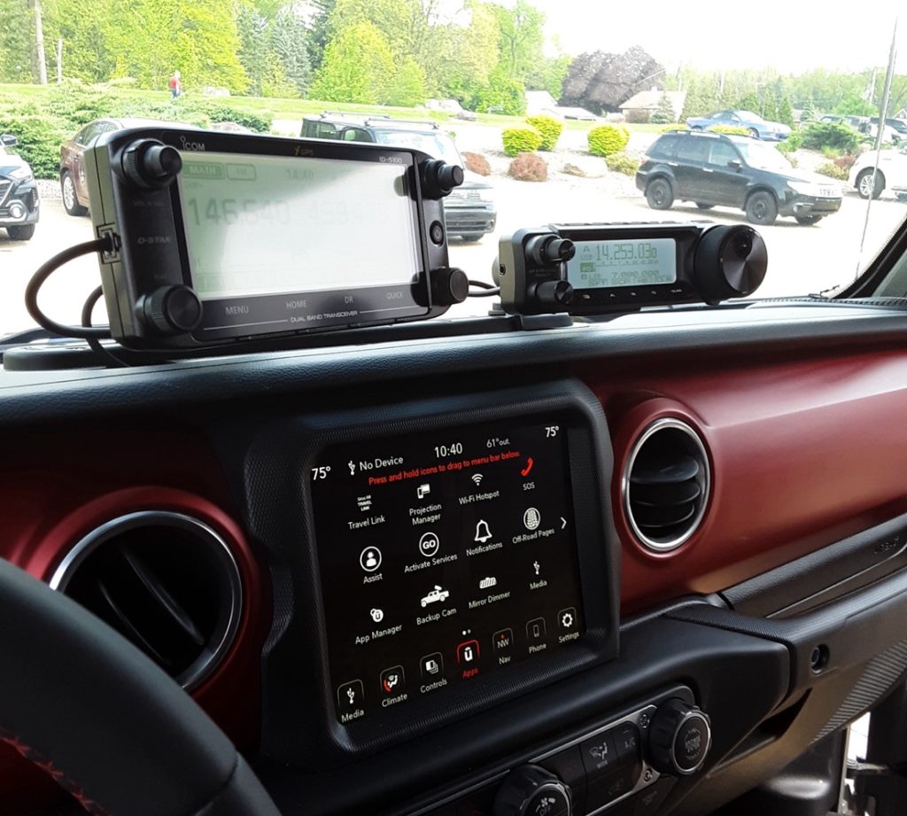 icom and yaseu radio control units in a jeep