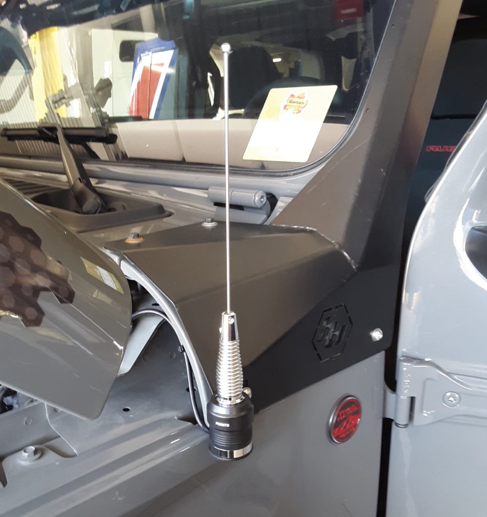 small radio antenna mounted on Jeep cowl