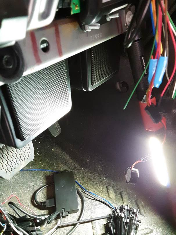 a pair of speakers mounted behind a vehicle dash