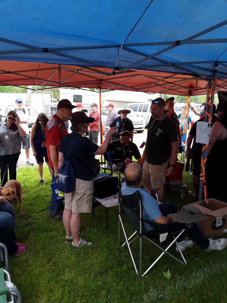 ham radio crowd gathered under awning