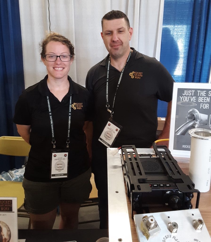 Two people in a trade show booth