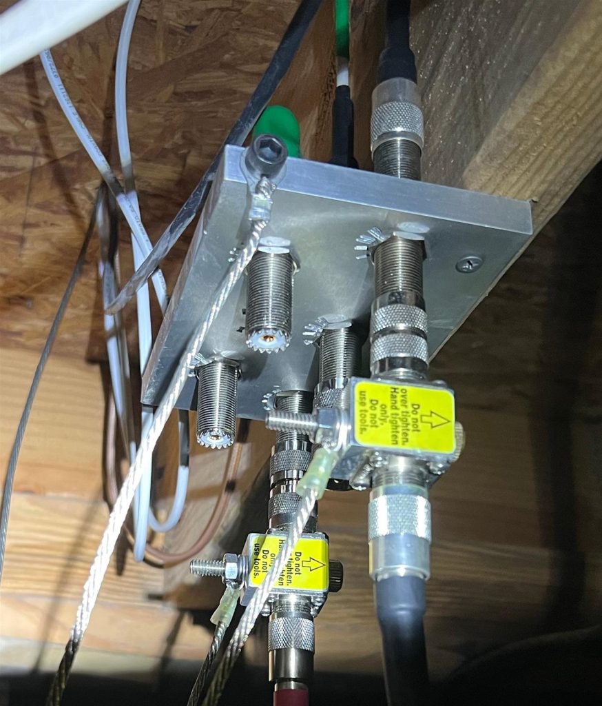large metal antenna bulkhead on a floor joist