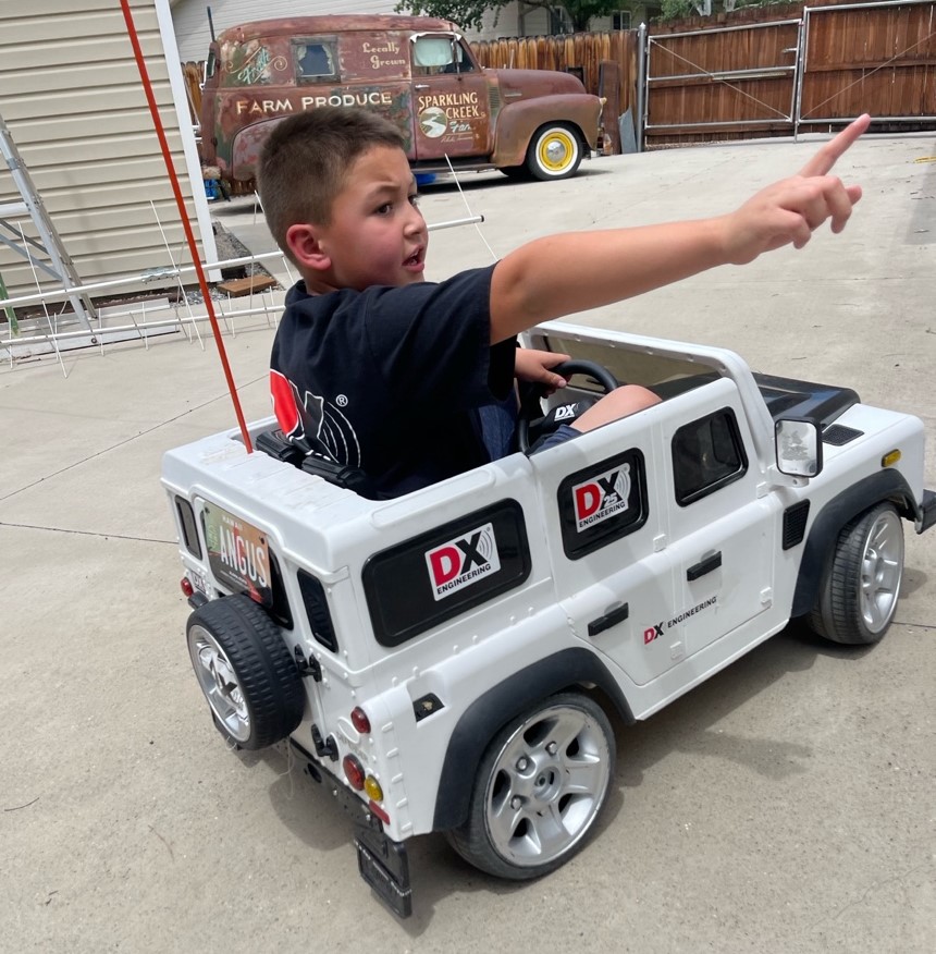 Young boy driving a power wheel Land Rover