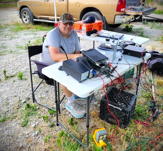 ham radio operator at field day portable station