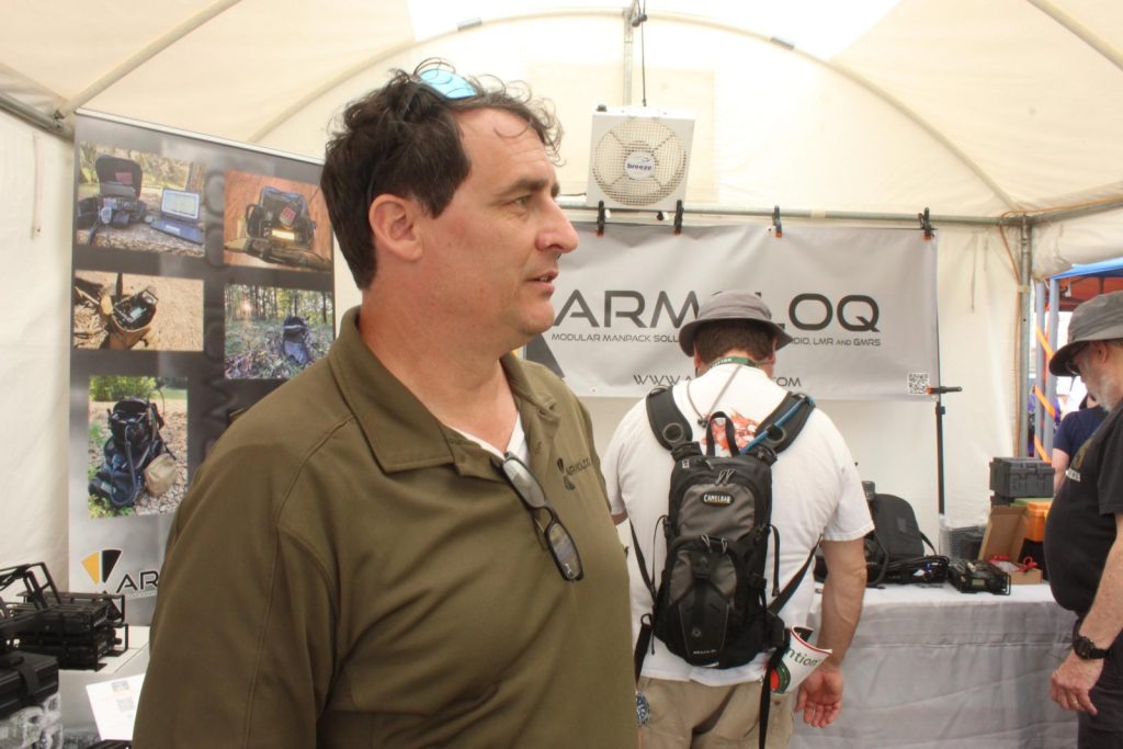 man standing in trade show booth