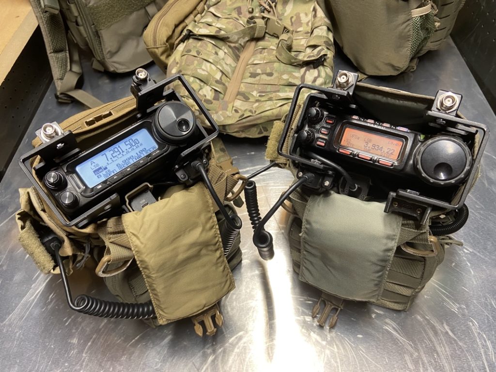 a pair of ham radios in portable field bags