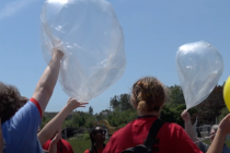 releasing a large weather balloon into the sky