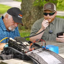 2 men at a portable amateur radio station outside