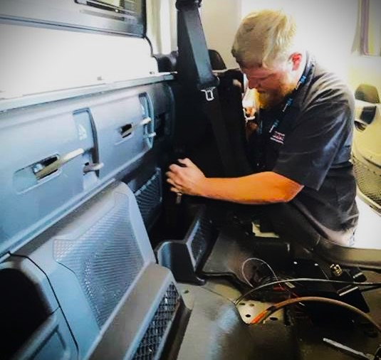man installing a ham radio in a truck