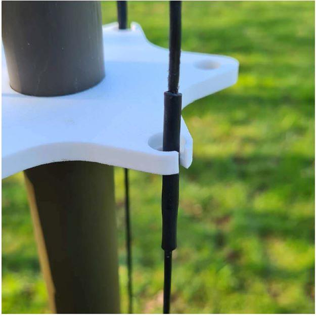 antenna guy line clipped in bracket