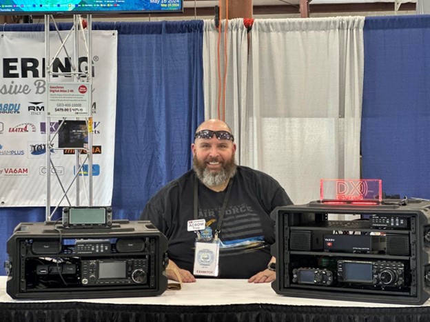 man sitting in ham radio trade show booth