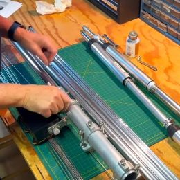 man assembling a ham radio antenna on a workbench